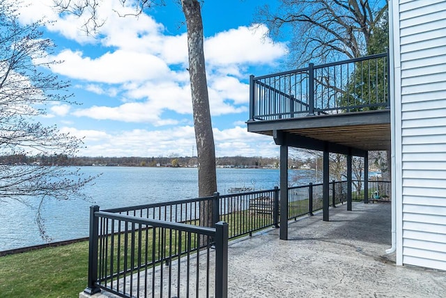 view of patio / terrace with a deck with water view