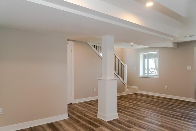 basement featuring dark wood-style flooring, baseboards, stairs, and recessed lighting