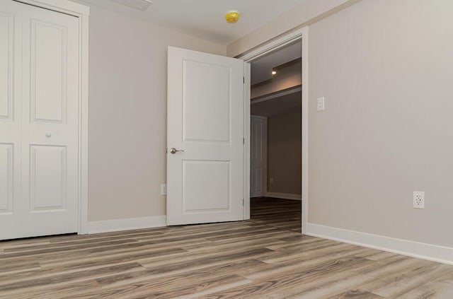 unfurnished bedroom with light wood-style floors and baseboards