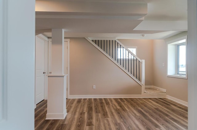 basement with wood finished floors, baseboards, and stairs