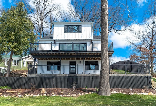 back of house featuring a deck and board and batten siding