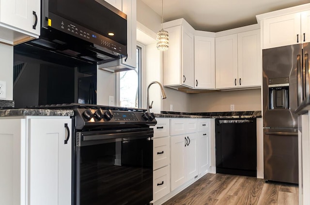 kitchen featuring black appliances, dark wood-type flooring, white cabinets, hanging light fixtures, and dark stone counters