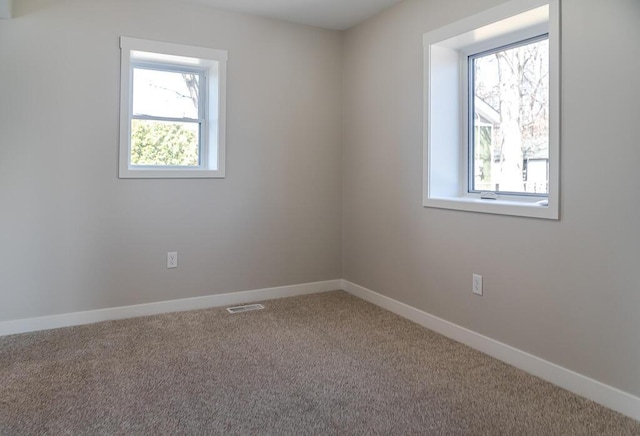 empty room with carpet and baseboards