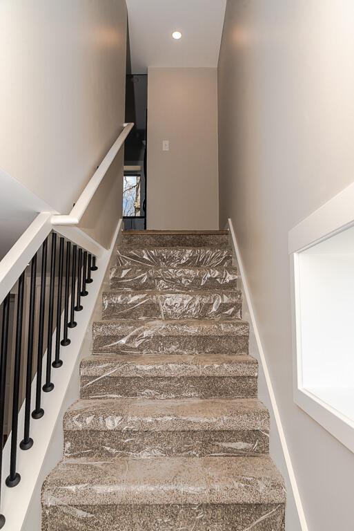 stairs featuring recessed lighting