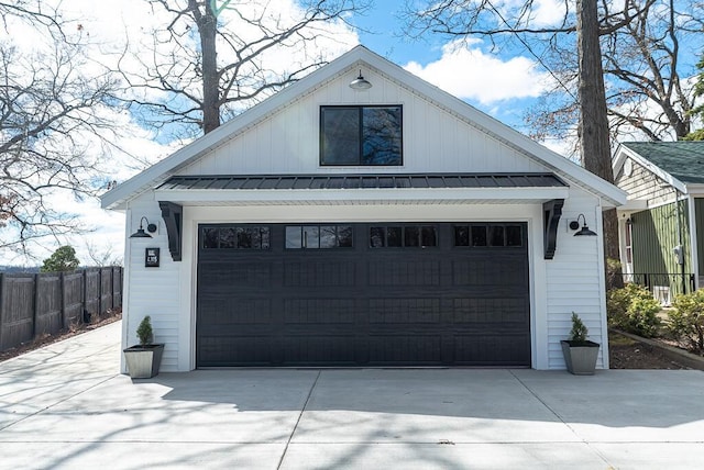 garage with fence and driveway