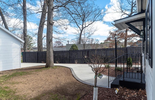 fenced backyard with a patio area