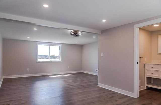 unfurnished room with dark wood-style flooring, baseboards, and recessed lighting