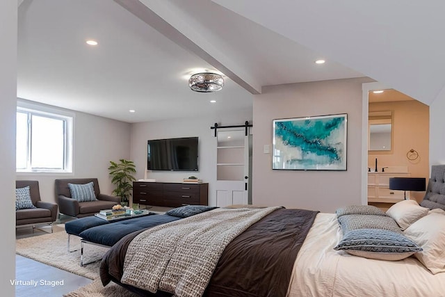 bedroom with a barn door, recessed lighting, and wood finished floors