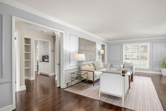 living area with dark wood-style floors, crown molding, baseboards, and built in shelves