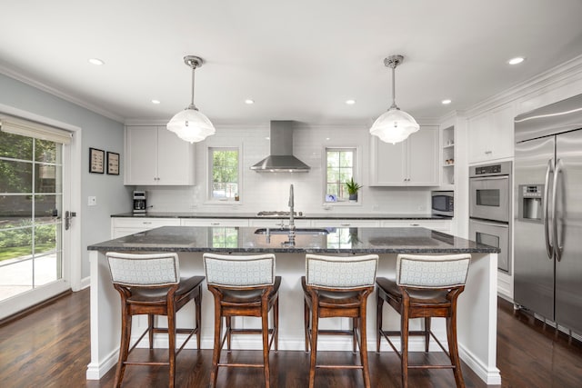 kitchen with wall chimney exhaust hood, stainless steel appliances, a sink, open shelves, and dark wood-style flooring