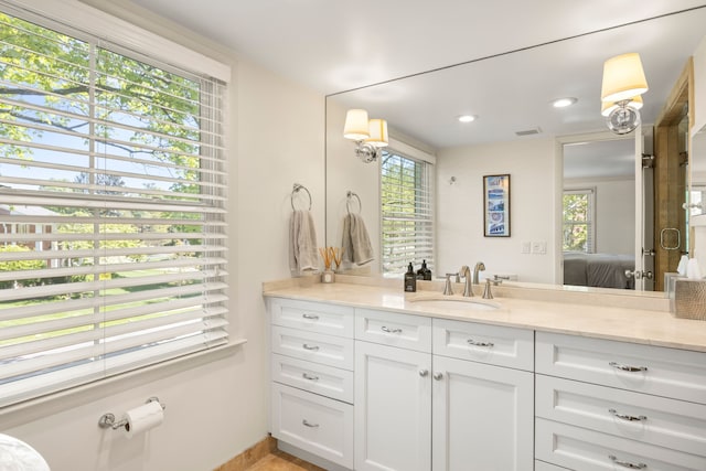 bathroom featuring healthy amount of natural light, ensuite bathroom, vanity, and recessed lighting