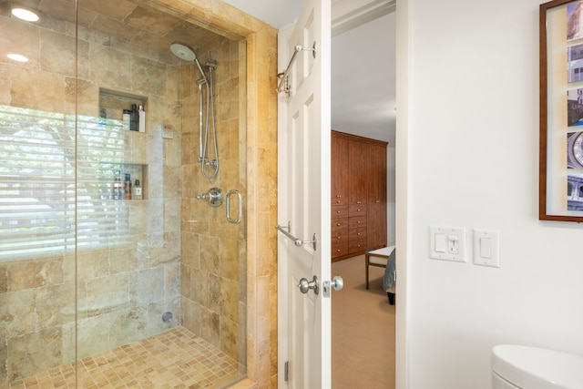 bathroom featuring a stall shower and toilet