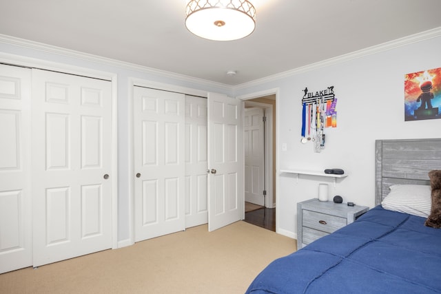 bedroom featuring multiple closets, ornamental molding, carpet, and baseboards