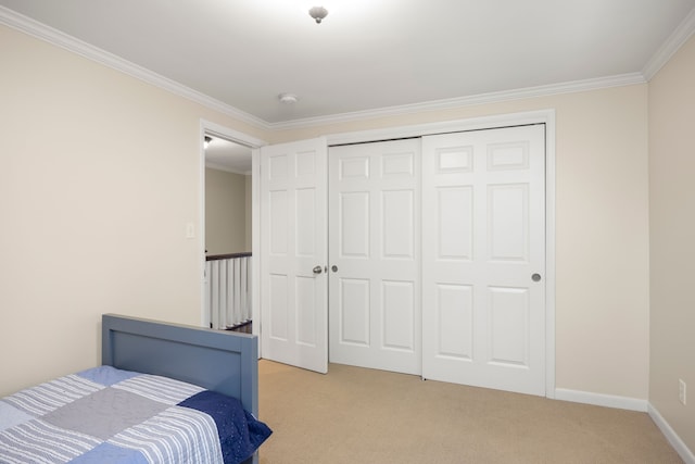 bedroom with crown molding, light colored carpet, a closet, and baseboards