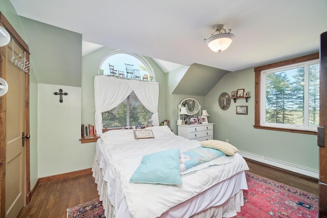 1621 W Beyer Rd, Ludington, MI 49431 - bedroom with a baseboard heating unit, dark wood-style flooring, vaulted ceiling, and baseboards