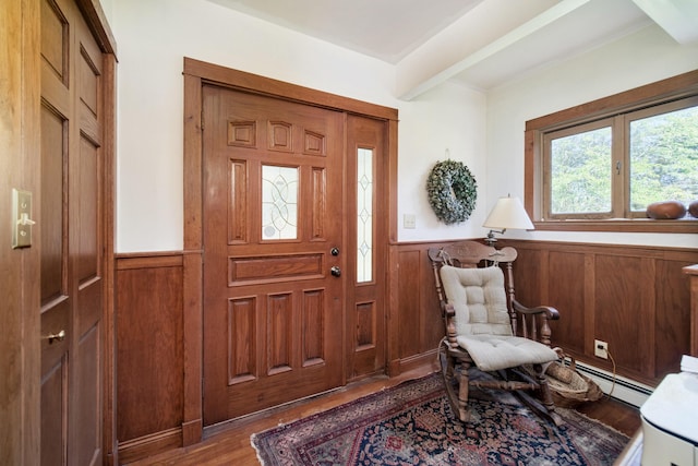 1621 W Beyer Rd, Ludington, MI 49431 - entryway with wainscoting, baseboard heating, wood finished floors, and beamed ceiling