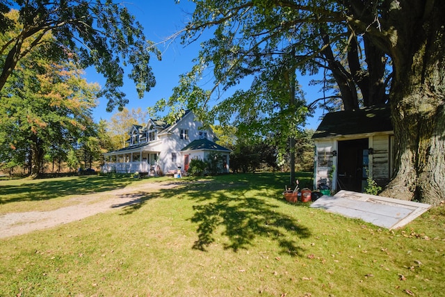 1621 W Beyer Rd, Ludington, MI 49431 - view of green lawn with an outbuilding and a porch
