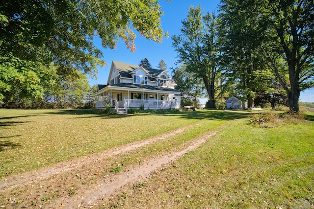 1621 W Beyer Rd, Ludington, MI 49431 - view of front facade featuring a porch and a front lawn