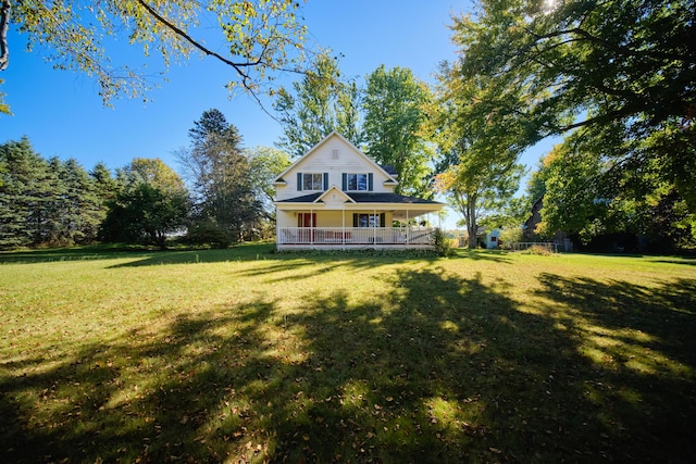 1621 W Beyer Rd, Ludington, MI 49431 - rear view of house featuring a porch and a lawn
