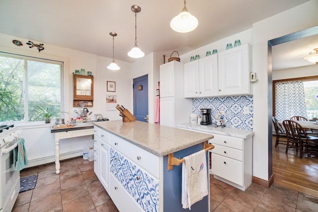 1621 W Beyer Rd, Ludington, MI 49431 - kitchen with baseboard heating, white range oven, tasteful backsplash, and white cabinetry