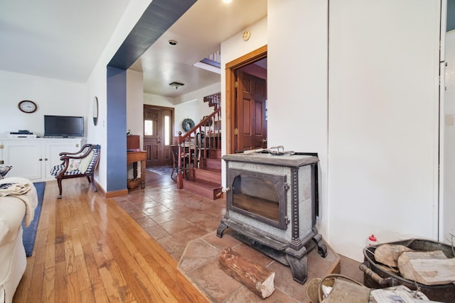 1621 W Beyer Rd, Ludington, MI 49431 - living area with stairs and a wood stove