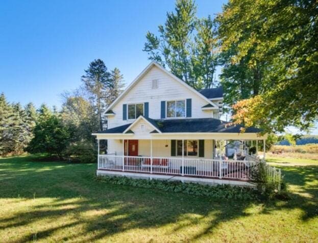 1621 W Beyer Rd, Ludington, MI 49431 - rear view of house featuring a lawn and a porch