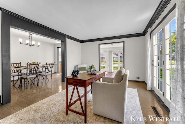 405 S 1st St, Edmore, MI 48829 - home office with crown molding, hardwood / wood-style flooring, and a chandelier