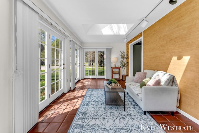 405 S 1st St, Edmore, MI 48829 - sunroom / solarium with french doors, tile patterned flooring, a skylight, and rail lighting
