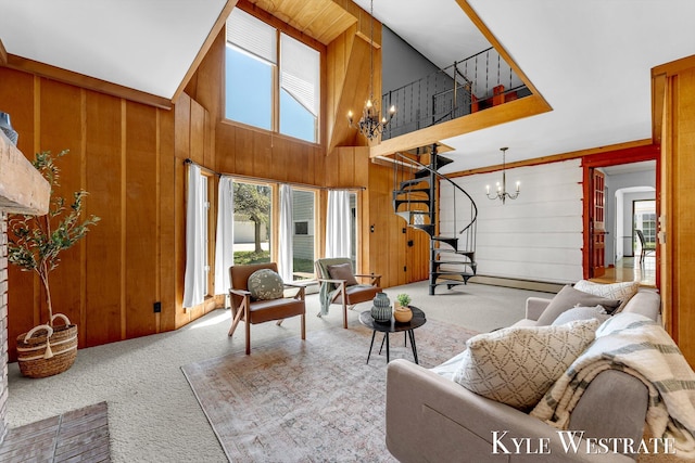 405 S 1st St, Edmore, MI 48829 - living area featuring a chandelier, carpet, wooden walls, a high ceiling, and a baseboard heating unit