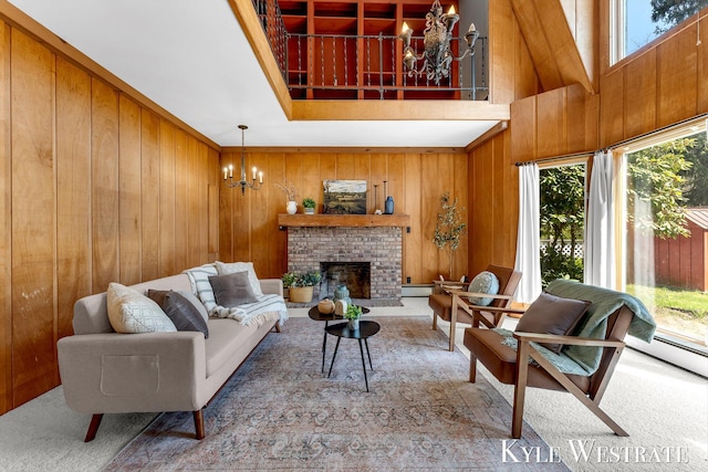 405 S 1st St, Edmore, MI 48829 - living area featuring a chandelier, carpet, wooden walls, a fireplace, and a baseboard radiator