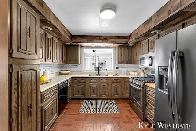 405 S 1st St, Edmore, MI 48829 - kitchen featuring appliances with stainless steel finishes, a sink, light countertops, and decorative backsplash