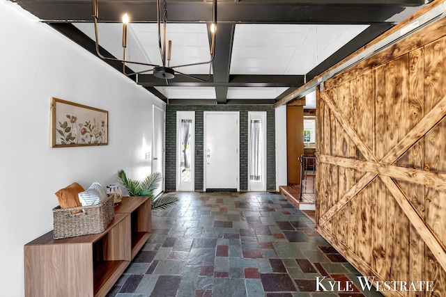 405 S 1st St, Edmore, MI 48829 - entryway with stone tile flooring, beam ceiling, coffered ceiling, and a barn door