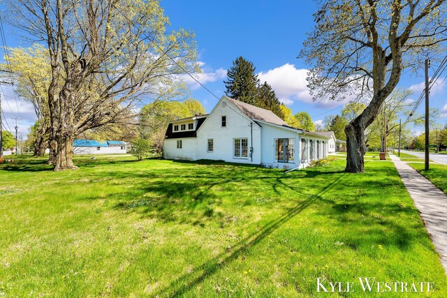 405 S 1st St, Edmore, MI 48829 - view of home's exterior featuring a lawn