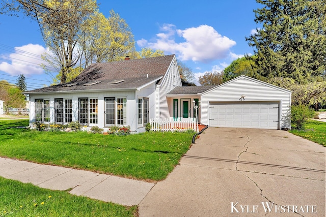 405 S 1st St, Edmore, MI 48829 - view of front of home featuring a garage, driveway, a front yard, roof with shingles, and a chimney