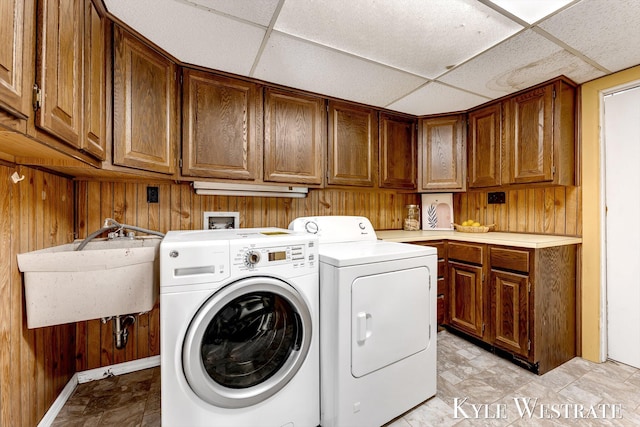 405 S 1st St, Edmore, MI 48829 - laundry room with cabinet space, wooden walls, independent washer and dryer, and baseboards