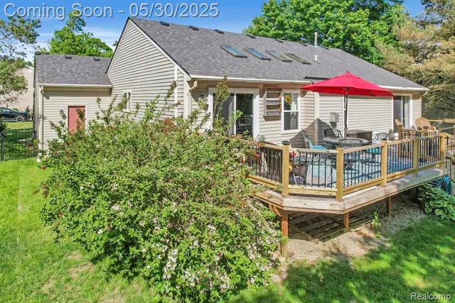 9450 Sandlewood Ct, Whitmore Lake, MI 48189 - back of property featuring a deck, a shingled roof, and a lawn
