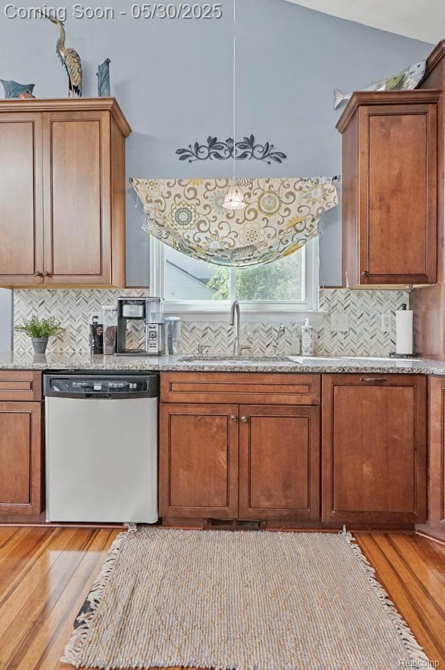 9450 Sandlewood Ct, Whitmore Lake, MI 48189 - kitchen featuring dishwasher, a sink, light wood-type flooring, and decorative backsplash