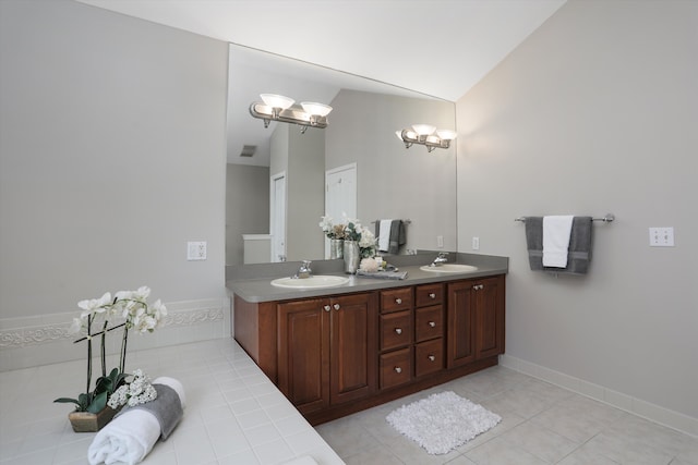 11638 Chandler Dr, Plymouth, MI 48170 - full bathroom featuring tile patterned floors, double vanity, lofted ceiling, and baseboards