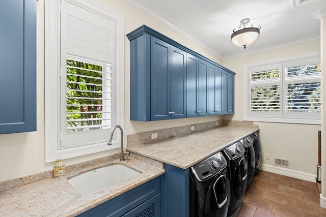 washroom featuring washer and dryer, cabinet space, crown molding, and baseboards