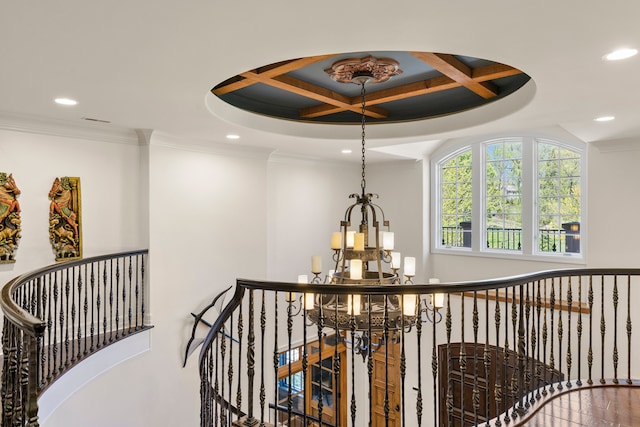 hall featuring a chandelier, an upstairs landing, recessed lighting, coffered ceiling, and ornamental molding