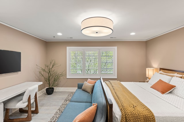 bedroom with wood finished floors, ornamental molding, recessed lighting, and baseboards