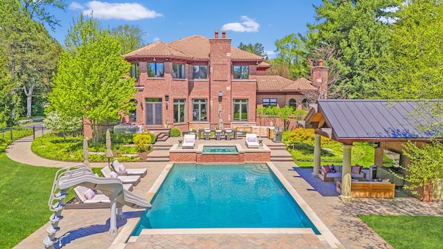 swimming pool featuring a patio area, an in-ground hot tub, outdoor lounge area, and fence