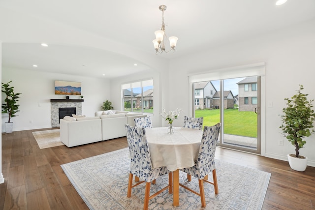 49793 Split Rock Rd, Macomb, MI 48044 - dining room featuring recessed lighting, a chandelier, wood finished floors, a glass covered fireplace, and baseboards