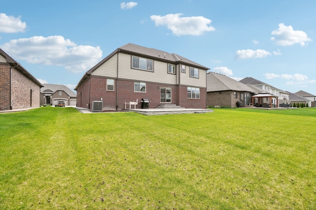 49793 Split Rock Rd, Macomb, MI 48044 - rear view of house featuring brick siding, a patio, a lawn, central AC unit, and a gazebo
