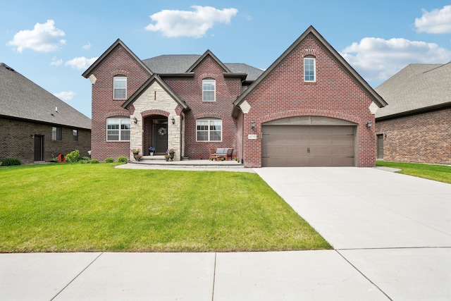 49793 Split Rock Rd, Macomb, MI 48044 - french country inspired facade featuring a front lawn, concrete driveway, stone siding, a garage, and brick siding