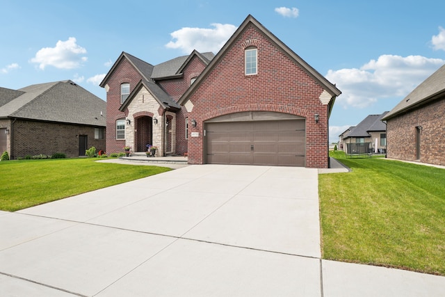 49793 Split Rock Rd, Macomb, MI 48044 - view of front of house featuring brick siding, a front yard, driveway, and a garage