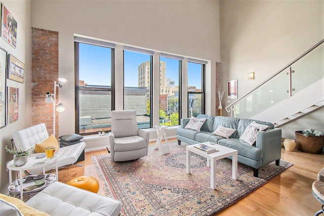101 W Liberty St Unit 320, Ann Arbor, MI 48104 - living area featuring wood finished floors, healthy amount of natural light, a high ceiling, and stairway