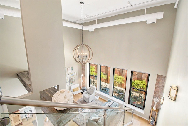 101 W Liberty St Unit 320, Ann Arbor, MI 48104 - dining room featuring wood finished floors, a towering ceiling, and a chandelier
