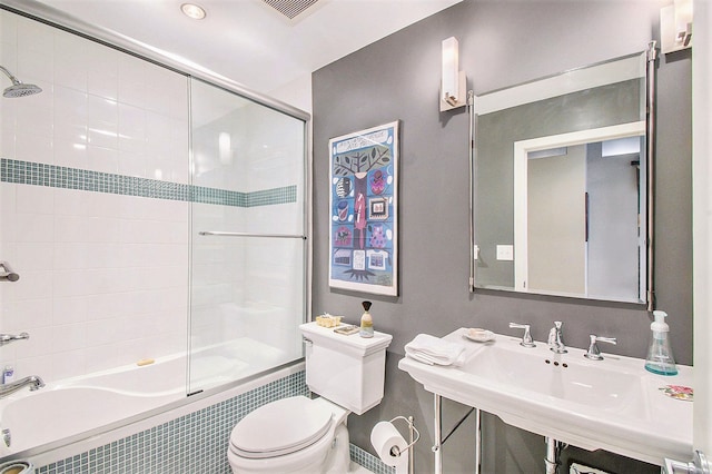 101 W Liberty St Unit 320, Ann Arbor, MI 48104 - full bathroom featuring toilet, tiled shower / bath combo, a sink, and baseboards