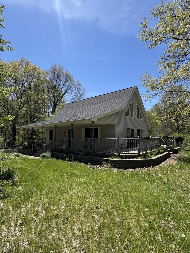 rear view of property with a porch and a yard